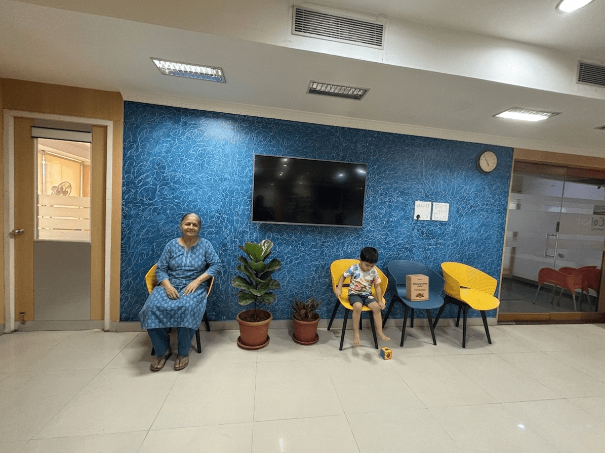 Patients and families in the consultation lounge before seeing the Vaidya